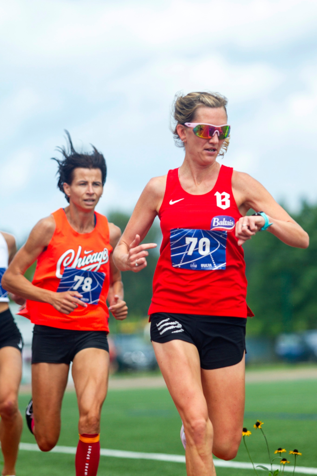 SK BULTA athlete checking her watch mid-race